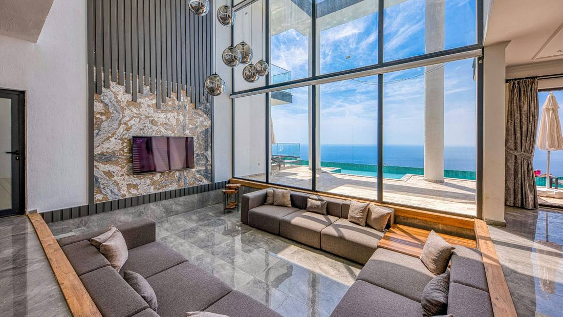 Open-concept living room with floor-to-ceiling windows and an ocean view
